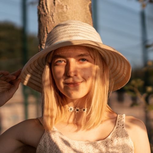 Girl with hat and dappled light
